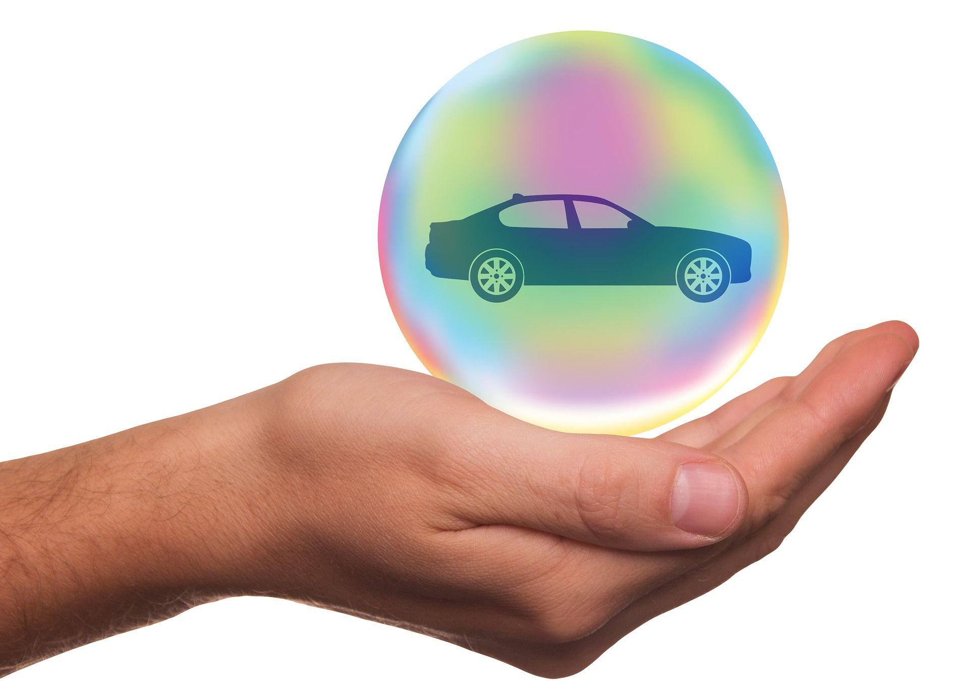 A hand holding a bubble with a car, representing car insurance.