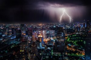 storm damage insurance claims - city at night and lightning thunder